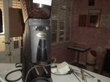 a coffee grinder sitting on a table in a kitchen