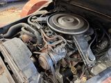 an old car with a very small engine in it ' s trunk