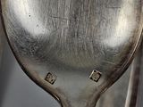 two spoons that are sitting next to each other