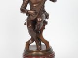 une image représentant une statue en bronze d'un homme tenant une épée