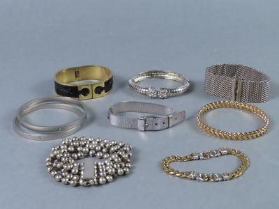 plusieurs types de bracelets et de bagues posés sur une table
