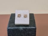 gold plated stud earrings on a marble block on a table