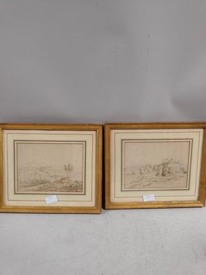 two framed prints of a landscape with a river and a village