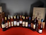 many bottles of wine sitting on a red table cloth
