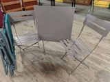 three chairs and a table in a room