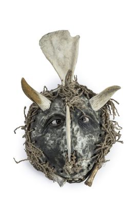 a close up of a mask with horns on a white background