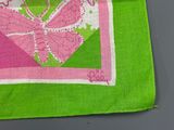 someone is sewing a butterfly on a pink and green cloth