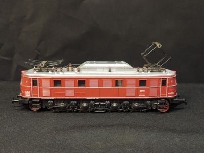 a red and white train car on a black background