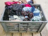 a crate full of clothes sitting on a pallet