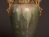 a vase that is sitting on a table with a black background