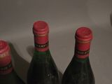 three bottles of wine sitting on a counter next to each other