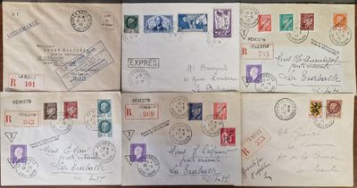 several envelopes with stamps and stamps on them sitting on a table