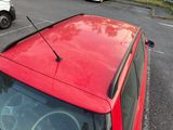 a red car that is parked in a parking lot