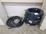 a bunch of hoses sitting on the ground next to each other