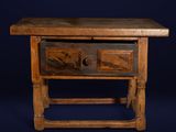 a small wooden table with two drawers on it