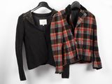 two jackets are hanging on a clothes rack in front of a white wall