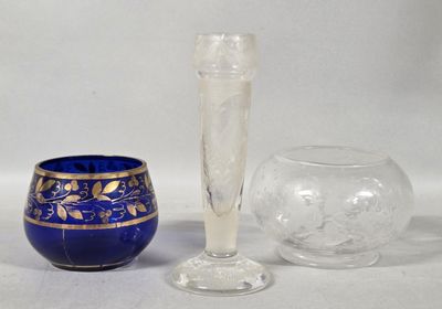 a blue vase and a glass sitting next to each other