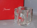 a red box and a clear glass candle holder on a table