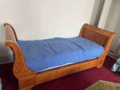 a bed with a blue cover on it in a room
