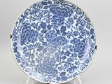 a blue and white plate with a floral design on it