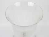 a clear glass vase with a small flower inside of it