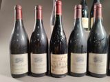 several bottles of wine are lined up on a table