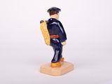 a small figurine of a man with a suitcase