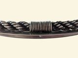 a close up of a metal bracelet with a braided design