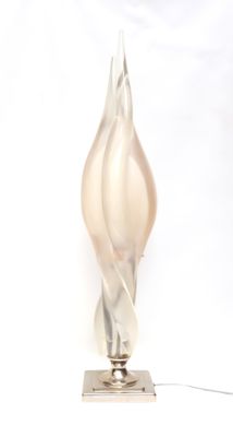 a glass lamp that is sitting on a metal stand