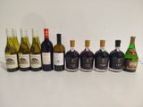 bottles of wine are lined up in a row on a white surface