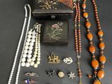 an assortment of jewelry including a necklace, earrings, and a box