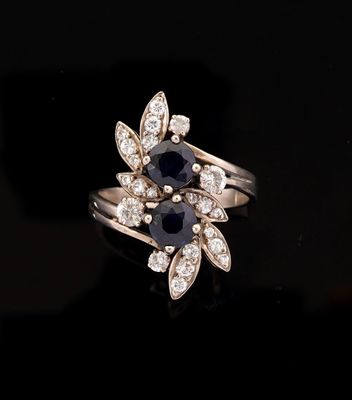 a close up of a black and white diamond ring on a black surface