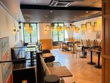 tables and chairs in a restaurant with a bar in the middle of the room