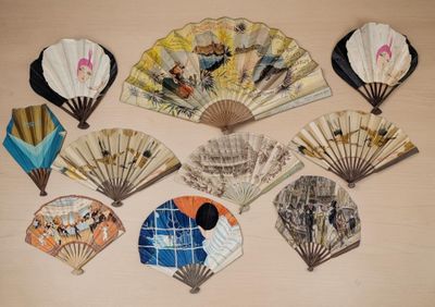 many different types of hand fans on the table
