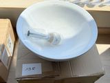 a white bowl sitting on top of a box next to a window