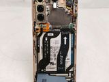 a broken cell phone sitting on a white surface