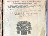 an old book with a bunch of writing on it sitting on a table