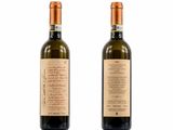 two bottles of wine are shown on a white surface