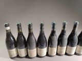 six bottles of wine are lined up in a row on a table