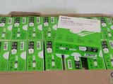 boxes of green and white electronic devices are stacked on top of each other