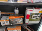 many boxes of electronics on a shelf in a store