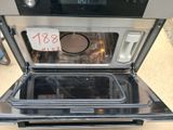 a black and silver oven that is open with a price tag on it