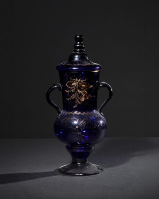 a blue vase with a dragon on it on a table
