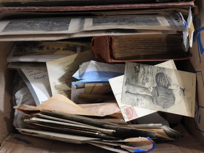 a cardboard box full of old papers and books