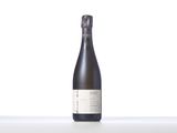 a bottle of wine sitting on top of a white table