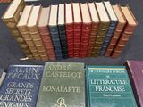 several books are stacked on a table in front of each other