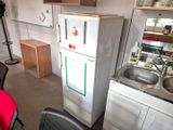 a small kitchen with a refrigerator and sink in it