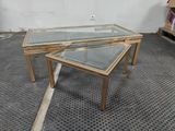 two tables with glass tops on a metal floor in a room