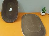 two speakers sitting on a table with a plant in the background
