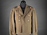 a brown jacket on a mannequin stand with a black background